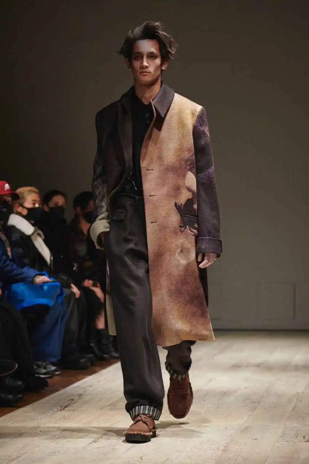 Classic herringbone pattern in a refined men's wool overcoat representing timeless elegance